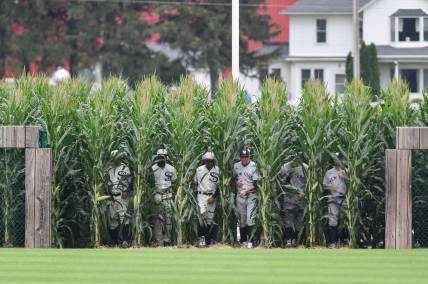 Aug 12, 2021; Dyersville, Iowa, USA; Members of the Chicago White Sox and New York Yankees enter the field before the game at Field of Dreams. Mandatory Credit: Jeffrey Becker-USA TODAY Sports