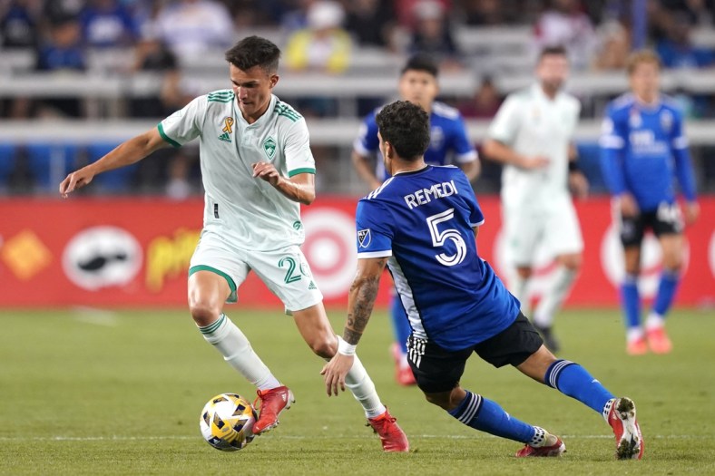 Sep 4, 2021; San Jose, California, USA; Colorado Rapids midfielder Cole Bassett (26) dribbles while being defended by San Jose Earthquakes midfielder Eric Remedi (5) during the first half at PayPal Park. Mandatory Credit: Darren Yamashita-USA TODAY Sports