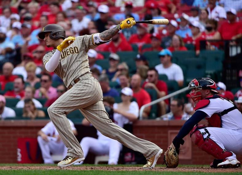 Sep 19, 2021; St. Louis, Missouri, USA;  San Diego Padres third baseman Manny Machado (13) hits a single during the eighth inning against the St. Louis Cardinals at Busch Stadium. Mandatory Credit: Jeff Curry-USA TODAY Sports
