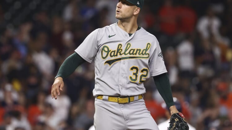 Oct 2, 2021; Houston, Texas, USA; Oakland Athletics starting pitcher James Kaprielian (32) reacts after a play during the sixth inning against the Houston Astros at Minute Maid Park. Mandatory Credit: Troy Taormina-USA TODAY Sports