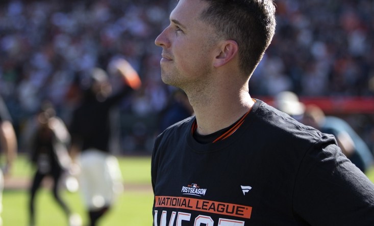 Oct 3, 2021; San Francisco, California, USA;  San Francisco Giants catcher Buster Posey takes in the scene as the team celebrates their 11-4 victory over the San Diego Padres at Oracle Park. The Giants clinched the National League West Division with the win. Mandatory Credit: D. Ross Cameron-USA TODAY Sports