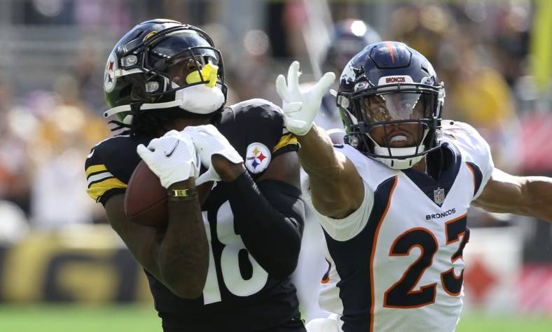 Oct 10, 2021; Pittsburgh, Pennsylvania, USA;  Pittsburgh Steelers wide receiver Diontae Johnson (18) catches a fifty yard touchdown pass behind Denver Broncos cornerback Kyle Fuller (23) during the first quarter at Heinz Field. Mandatory Credit: Charles LeClaire-USA TODAY Sports