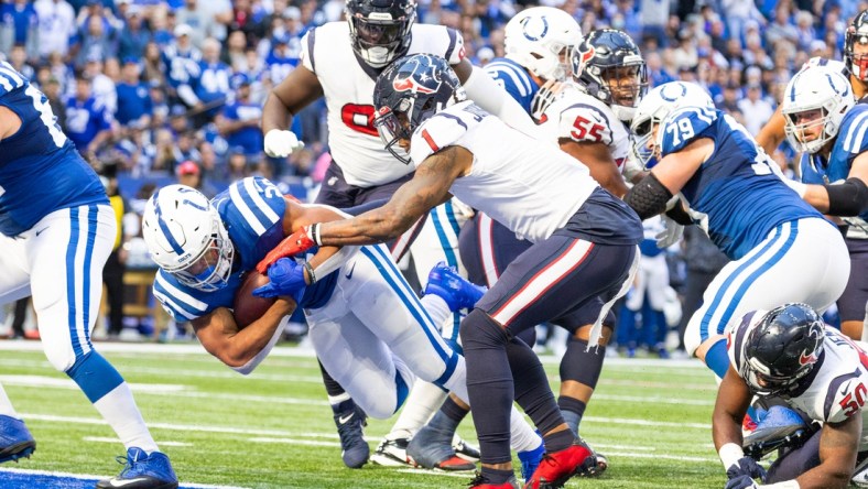 Oct 17, 2021; Indianapolis, Indiana, USA; Indianapolis Colts running back Jonathan Taylor (28) scores a touchdown while Houston Texans safety Lonnie Johnson (1) defends  in the second half at Lucas Oil Stadium. Mandatory Credit: Trevor Ruszkowski-USA TODAY Sports