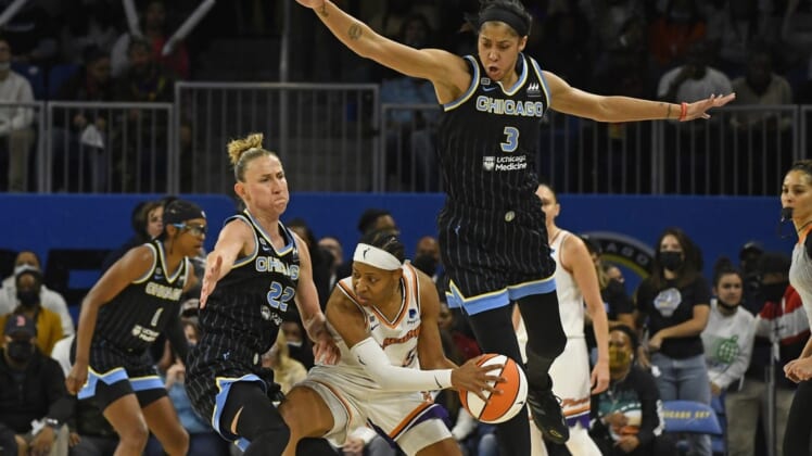 Oct 17, 2021; Chicago, Illinois, USA; Chicago Sky guard Courtney Vandersloot (22) and Chicago Sky forward/center Candace Parker (3) block Phoenix Mercury guard Shey Peddy (5) during the second half of game four of the 2021 WNBA Finals at Wintrust Arena. Mandatory Credit: Matt Marton-USA TODAY Sports
