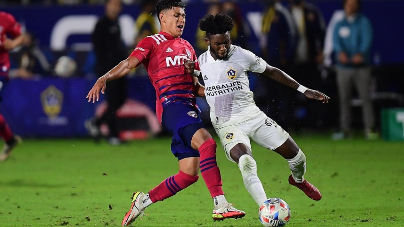 Oct 23, 2021; Carson, California, USA; FC Dallas midfielder Edwin Cerrillo (6) plays for the ball against Los Angeles Galaxy midfielder Oniel Fisher (91) during the second half at StubHub Center. Mandatory Credit: Gary A. Vasquez-USA TODAY Sports