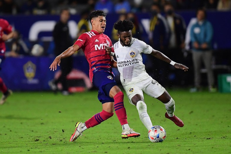 Oct 23, 2021; Carson, California, USA; FC Dallas midfielder Edwin Cerrillo (6) plays for the ball against Los Angeles Galaxy midfielder Oniel Fisher (91) during the second half at StubHub Center. Mandatory Credit: Gary A. Vasquez-USA TODAY Sports