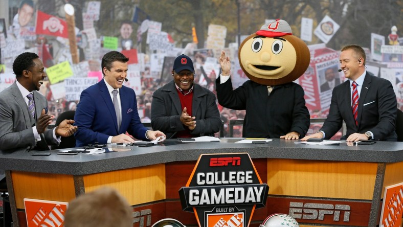 Lee Corso waves while wearing a Brutus Buckeye head as, from left, Desmond Howard, Rece Davis, Archie Griffin, and Kirk Herbstreit applaud his pick during ESPN's College GameDay broadcast from the campus of Ohio State prior to the NCAA football game against the Michigan State Spartans in Columbus on Nov. 21, 2015. (Adam Cairns / The Columbus Dispatch)

Osu15msu Ac 07