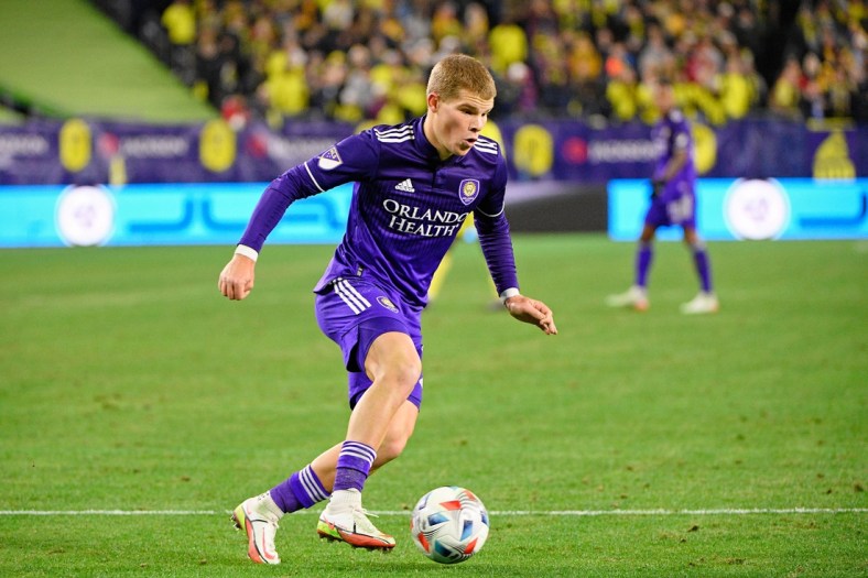 Nov 23, 2021; Nashville, TN, USA; Orlando City forward Chris Mueller (9) dribbles the ball against Nashville SC during the second half of a round one MLS Playoff game at Nissan Stadium. Mandatory Credit: Steve Roberts-USA TODAY Sports
