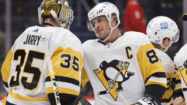 Dec 10, 2021; Washington, District of Columbia, USA; Pittsburgh Penguins goaltender Tristan Jarry (35) celebrates with Penguins center Sidney Crosby (87) after their game against the Washington Capitals at Capital One Arena. Mandatory Credit: Geoff Burke-USA TODAY Sports