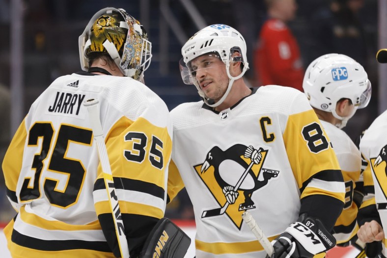 Dec 10, 2021; Washington, District of Columbia, USA; Pittsburgh Penguins goaltender Tristan Jarry (35) celebrates with Penguins center Sidney Crosby (87) after their game against the Washington Capitals at Capital One Arena. Mandatory Credit: Geoff Burke-USA TODAY Sports