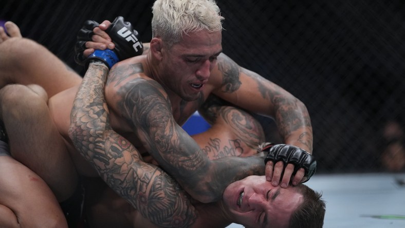 Dec 11, 2021; Las Vegas, Nevada, USA; Charles Oliveira pins Dustin Poirier to the mat during UFC 269 at T-Mobile Arena. Mandatory Credit: Stephen R. Sylvanie-USA TODAY Sports