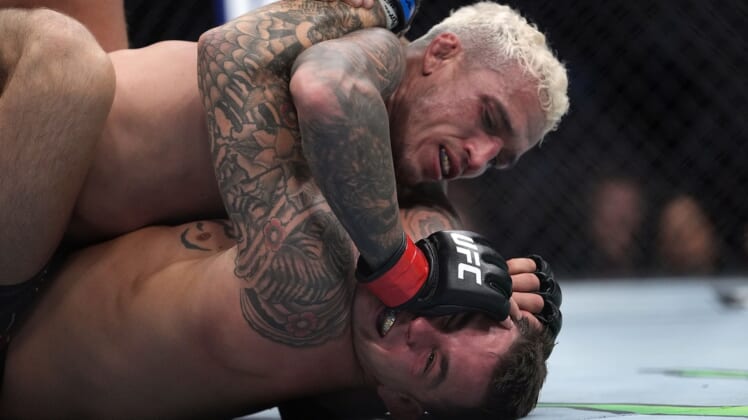 Dec 11, 2021; Las Vegas, Nevada, USA; Charles Oliveira pins Dustin Poirier to the mat during UFC 269 at T-Mobile Arena. Mandatory Credit: Stephen R. Sylvanie-USA TODAY Sports