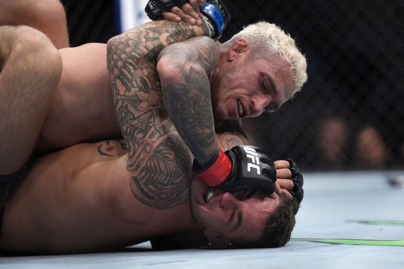 Dec 11, 2021; Las Vegas, Nevada, USA; Charles Oliveira pins Dustin Poirier to the mat during UFC 269 at T-Mobile Arena. Mandatory Credit: Stephen R. Sylvanie-USA TODAY Sports