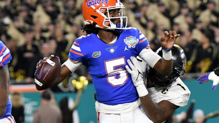 Dec 23, 2021; Tampa, FL, USA;  Florida Gators quarterback Emory Jones (5) is hit by UCF Knights defensive lineman Big Kat Bryant (1) on a pass attempt in the first half of the Gasparilla Bowl at Raymond James Stadium. Mandatory Credit: Jonathan Dyer-USA TODAY Sports