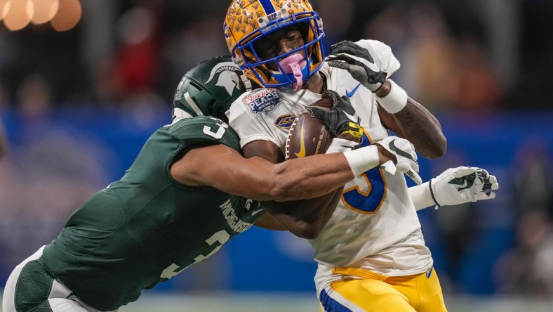 Dec 30, 2021; Atlanta, GA, USA; Pittsburgh Panthers wide receiver Jordan Addison (3) is tackled by Michigan State Spartans safety Xavier Henderson (3) after a long pass reception during the first half during the 2021 Peach Bowl at Mercedes-Benz Stadium. Mandatory Credit: Dale Zanine-USA TODAY Sports