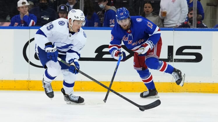 Jan 2, 2022; New York, New York, USA;  Tampa Bay Lightning left wing Ross Colton (79) and New York Rangers left wing Alexis Lafreniere (13) battle for the puck during the second period at Madison Square Garden. Mandatory Credit: Gregory Fisher-USA TODAY Sports