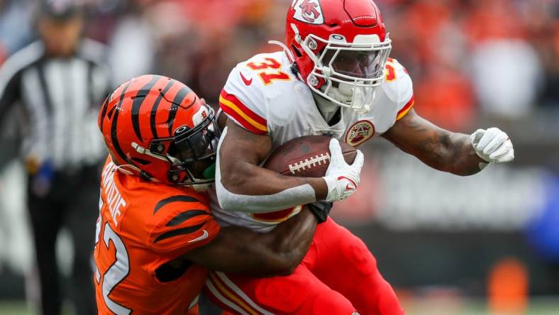 Jan 2, 2022; Cincinnati, Ohio, USA; Cincinnati Bengals cornerback Chidobe Awuzie (22) brings down Kansas City Chiefs running back Darrel Williams (31) in the first half at Paul Brown Stadium. Mandatory Credit: Katie Stratman-USA TODAY Sports