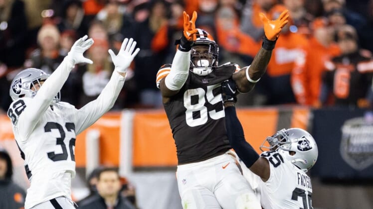 Dec 20, 2021; Cleveland, Ohio, USA; Cleveland Browns tight end David Njoku (85) leaps for the ball along with Las Vegas Raiders defensive back Dallin Leavitt (32) and cornerback Brandon Facyson (35) during the fourth quarter at FirstEnergy Stadium. Mandatory Credit: Scott Galvin-USA TODAY Sports
