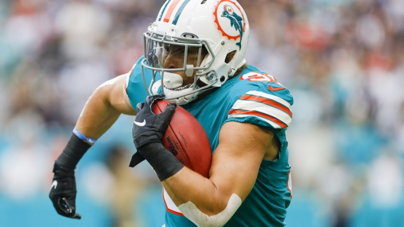 Jan 9, 2022; Miami Gardens, Florida, USA;Miami Dolphins running back Phillip Lindsay (31) runs with the football against the New England Patriots during the first quarter at Hard Rock Stadium. Mandatory Credit: Sam Navarro-USA TODAY Sports