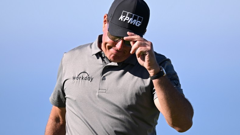 Jan 27, 2022; San Diego, California, USA; Phil Mickelson acknowledges the crowd after a putt on the fourth green during the first round of the Farmers Insurance Open golf tournament at Torrey Pines Municipal Golf Course - South Course. Mandatory Credit: Orlando Ramirez-USA TODAY Sports