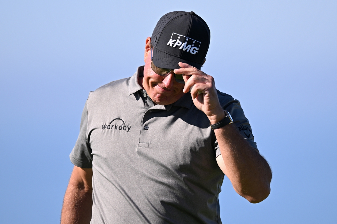 Jan 27, 2022; San Diego, California, USA; Phil Mickelson acknowledges the crowd after a putt on the fourth green during the first round of the Farmers Insurance Open golf tournament at Torrey Pines Municipal Golf Course - South Course. Mandatory Credit: Orlando Ramirez-USA TODAY Sports