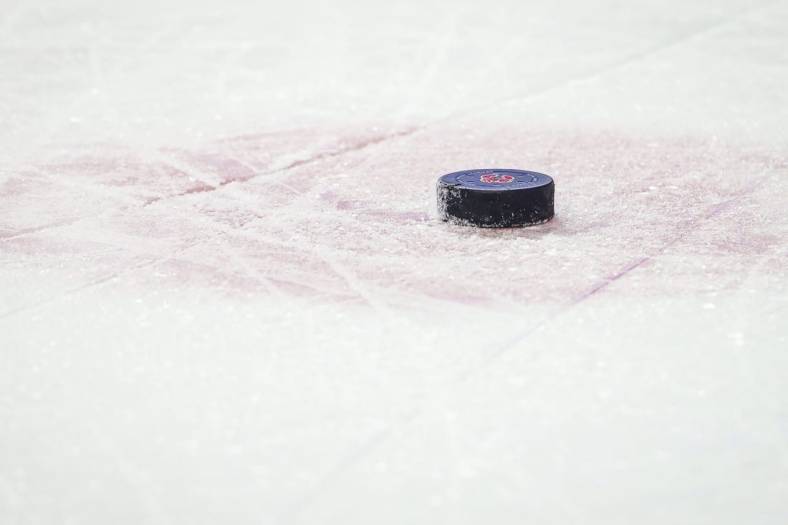 Jan 29, 2022; Calgary, Alberta, CAN; General view of the hockey puck during the third period between the Calgary Flames and the Vancouver Canucks at Scotiabank Saddledome. Mandatory Credit: Sergei Belski-USA TODAY Sports