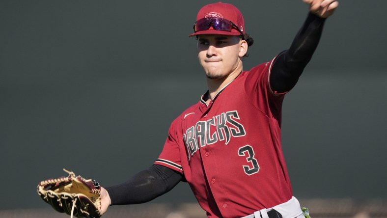 Feb 21, 2022; Scottsdale, Ariz., U.S.;  Diamondbacks minor league outfielder Alek Thomas throws during a select training camp for minor-league players not covered by the Players Association at Salt River Fields. MLB continues to be in a lockout after the expiration of the collective bargaining agreement Dec. 2. Mandatory Credit: Michael Chow-Arizona Republic

Baseball Diamondbacks Select Minor League Camp