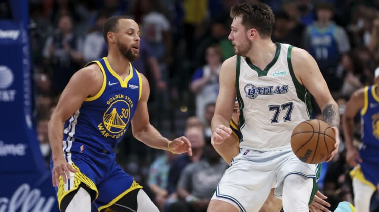 Mar 3, 2022; Dallas, Texas, USA;  Dallas Mavericks guard Luka Doncic (77) dribbles as Golden State Warriors guard Stephen Curry (30) defends during the game at American Airlines Center. Mandatory Credit: Kevin Jairaj-USA TODAY Sports