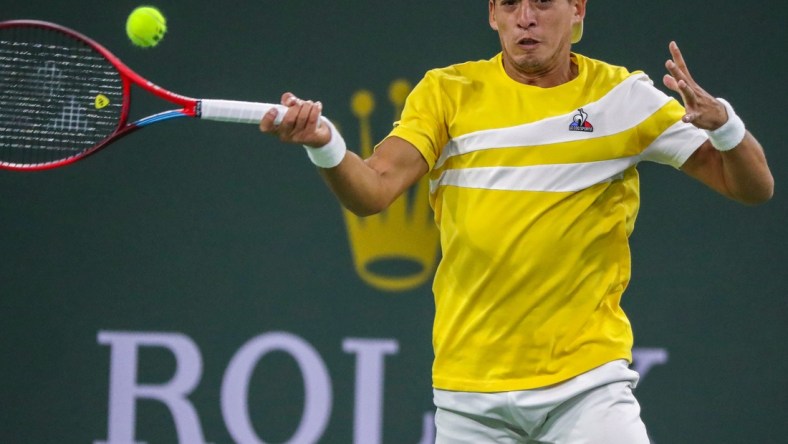 Sebastian Baez of Argentina returns the ball to Nick Kyrgios of Australia during round one of the BNP Paribas Open at the Indian Wells Tennis Garden in Indian Wells, Calif., Thursday, March 10, 2022.