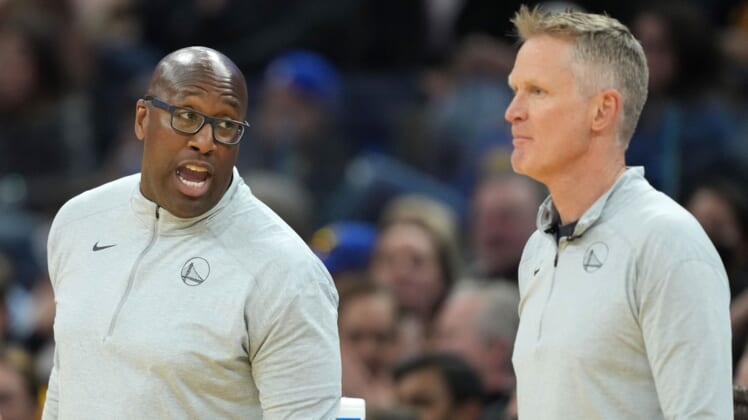 Mar 8, 2022; San Francisco, California, USA; Golden State Warriors assistant coach Mike Brown talks to head coach Steve Kerr during the third quarter against the LA Clippers at Chase Center. Mandatory Credit: Darren Yamashita-USA TODAY Sports