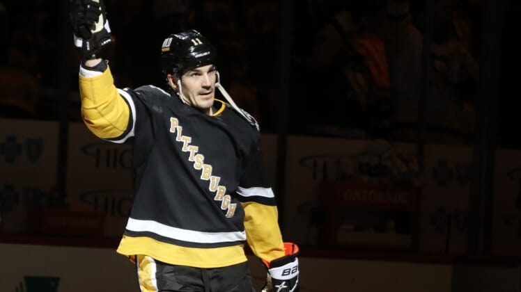 Mar 13, 2022; Pittsburgh, Pennsylvania, USA;  Pittsburgh Penguins center Brian Boyle (11) reacts after being named first star of the game against the Carolina Hurricanes at PPG Paints Arena. The Penguins won 4-2. Mandatory Credit: Charles LeClaire-USA TODAY Sports