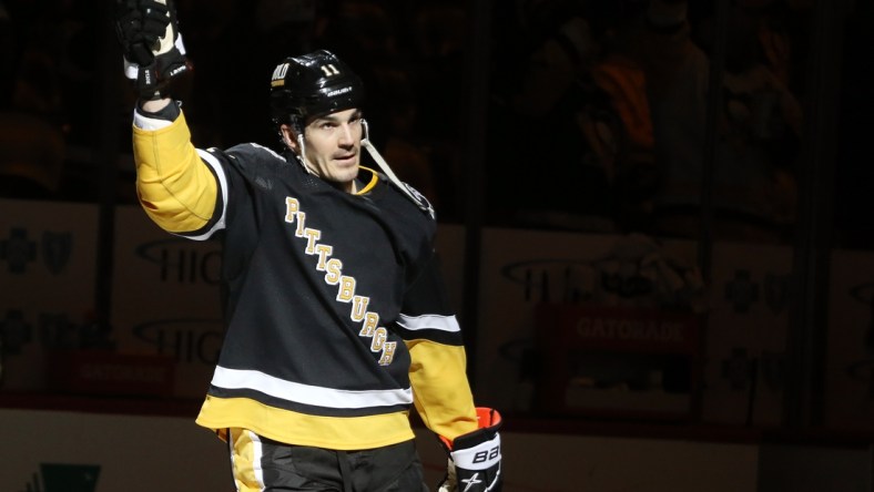 Mar 13, 2022; Pittsburgh, Pennsylvania, USA;  Pittsburgh Penguins center Brian Boyle (11) reacts after being named first star of the game against the Carolina Hurricanes at PPG Paints Arena. The Penguins won 4-2. Mandatory Credit: Charles LeClaire-USA TODAY Sports