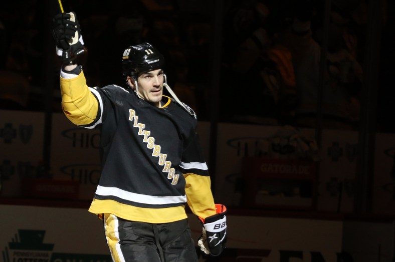 Mar 13, 2022; Pittsburgh, Pennsylvania, USA;  Pittsburgh Penguins center Brian Boyle (11) reacts after being named first star of the game against the Carolina Hurricanes at PPG Paints Arena. The Penguins won 4-2. Mandatory Credit: Charles LeClaire-USA TODAY Sports