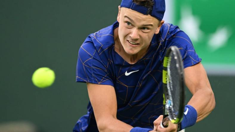 Mar 13, 2022; Indian Wells, CA, USA;  Holger Rune (DEN)  hits a shot against Matteo Berrettini (ITA) during his third round match at the BNP Paribas Open at the Indian Wells Tennis Garden. Mandatory Credit: Jayne Kamin-Oncea-USA TODAY Sports