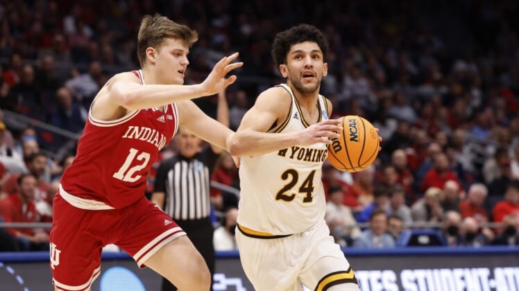 Mar 15, 2022; Dayton, OH, USA; Wyoming Cowboys guard Hunter Maldonado (24) looks to move the ball defended by Indiana Hoosiers forward Miller Kopp (12) in the second half during the First Four of the 2022 NCAA Tournament at UD Arena. Mandatory Credit: Rick Osentoski-USA TODAY Sports