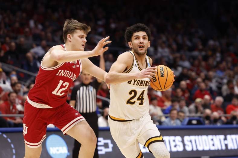 Mar 15, 2022; Dayton, OH, USA; Wyoming Cowboys guard Hunter Maldonado (24) looks to move the ball defended by Indiana Hoosiers forward Miller Kopp (12) in the second half during the First Four of the 2022 NCAA Tournament at UD Arena. Mandatory Credit: Rick Osentoski-USA TODAY Sports