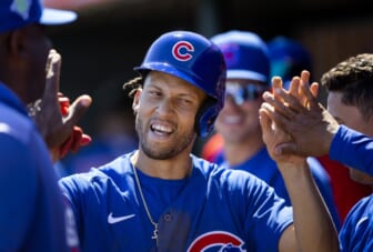 Mar 24, 2022; Tempe, Arizona, USA; Chicago Cubs infielder Andrelton Simmons celebrates with teammates after scoring against the Los Angeles Angels during a spring training game at Tempe Diablo Stadium. Mandatory Credit: Mark J. Rebilas-USA TODAY Sports