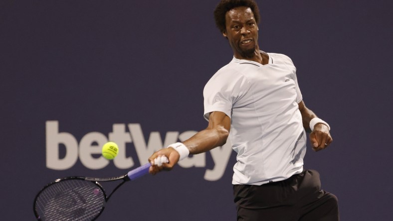 Mar 27, 2022; Miami Gardens, FL, USA; Gael Monfils (FRA) hits a forehand against Francisco Cerundolo (ARG)(not pictured) in a third round men's singles match in the Miami Open at Hard Rock Stadium. Mandatory Credit: Geoff Burke-USA TODAY Sports