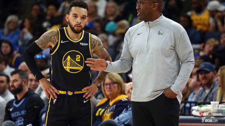 Mar 28, 2022; Memphis, Tennessee, USA; Golden State Warriors assistant coach Mike Brown (right) talks with guard Chris Chiozza (2) during the second half at FedExForum. Brown took over head coaching duties after head coach Steve Kerr (not pictured) was ejected from the game. Mandatory Credit: Petre Thomas-USA TODAY Sports