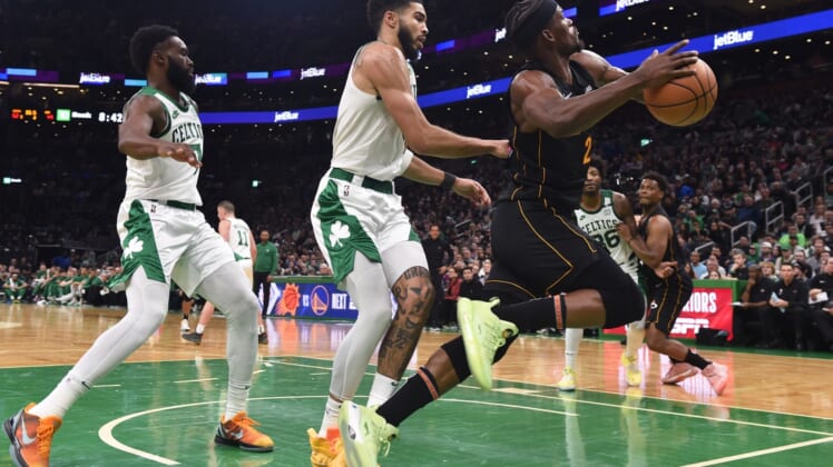 Mar 30, 2022; Boston, Massachusetts, USA; Boston Celtics forward Jayson Tatum (0) fouls Miami Heat forward Jimmy Butler (22) during the first half at TD Garden. Mandatory Credit: Bob DeChiara-USA TODAY Sports