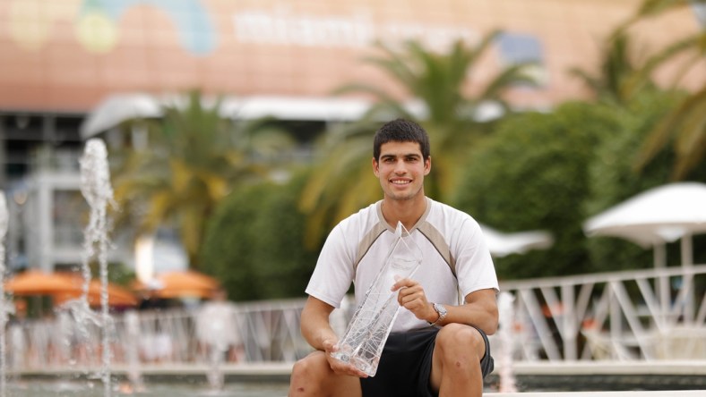 Apr 3, 2022; Miami Gardens, FL, USA; Carlos Alcaraz (ESP) poses for a portrait while holding the Butch Buchholz Championship Trophy after winning the men's singles final in the Miami Open at Hard Rock Stadium. Mandatory Credit: Geoff Burke-USA TODAY Sports