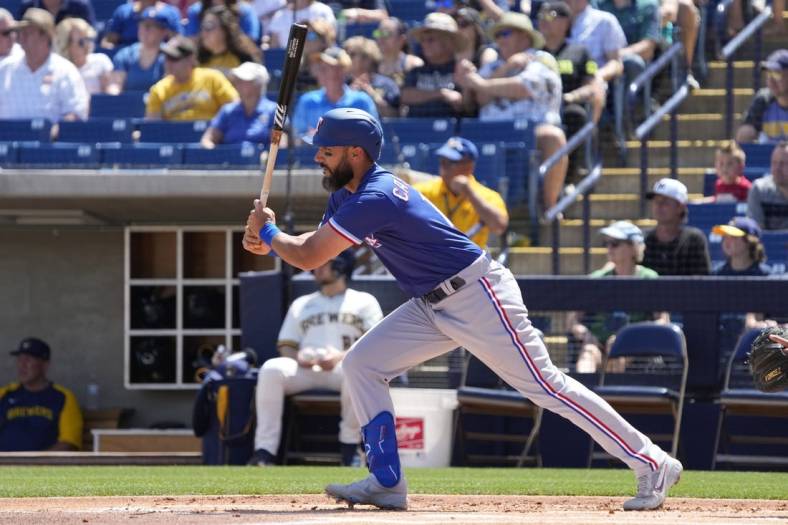 Apr 3, 2022; Phoenix, Arizona, USA; Texas Rangers first baseman Matt Carpenter (12) hits against the Milwaukee Brewers in the first inning during a spring training game at American Family Fields of Phoenix. Mandatory Credit: Rick Scuteri-USA TODAY Sports