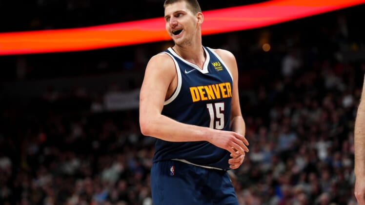 Apr 5, 2022; Denver, Colorado, USA; Denver Nuggets center Nikola Jokic (15) reacts in the second quarter against the San Antonio Spurs at Ball Arena. Mandatory Credit: Ron Chenoy-USA TODAY Sports