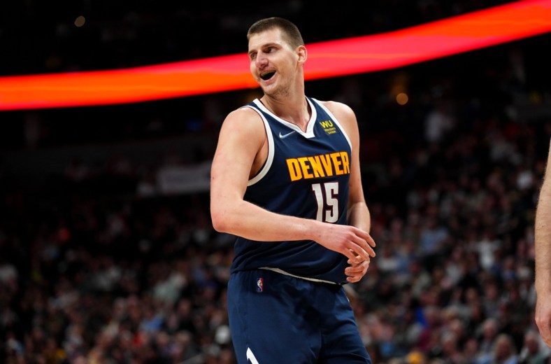 Apr 5, 2022; Denver, Colorado, USA; Denver Nuggets center Nikola Jokic (15) reacts in the second quarter against the San Antonio Spurs at Ball Arena. Mandatory Credit: Ron Chenoy-USA TODAY Sports