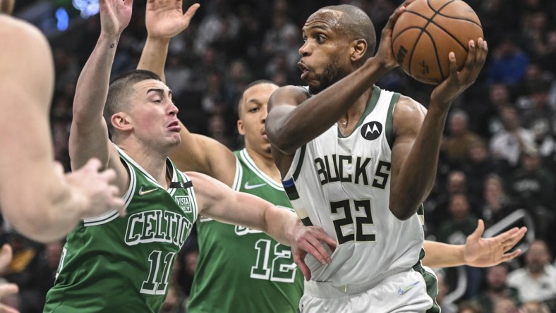 Apr 7, 2022; Milwaukee, Wisconsin, USA;  Milwaukee Bucks forward Khris Middleton (22) gets pressure from Boston Celtics guard Payton Pritchard (11) in the first quarter at Fiserv Forum. Mandatory Credit: Benny Sieu-USA TODAY Sports