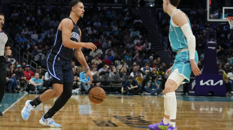 Apr 7, 2022; Charlotte, North Carolina, USA; Orlando Magic guard Jalen Suggs (4) dribbles the ball while defended by Charlotte Hornets guard LaMelo Ball (2) during the second half at Spectrum Center. Mandatory Credit: Jim Dedmon-USA TODAY Sports