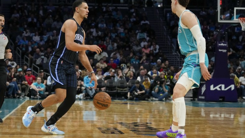 Apr 7, 2022; Charlotte, North Carolina, USA; Orlando Magic guard Jalen Suggs (4) dribbles the ball while defended by Charlotte Hornets guard LaMelo Ball (2) during the second half at Spectrum Center. Mandatory Credit: Jim Dedmon-USA TODAY Sports