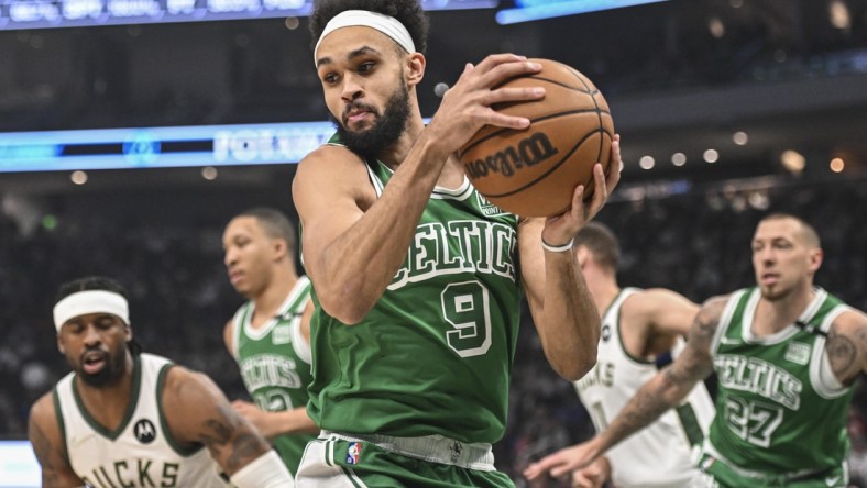 Apr 7, 2022; Milwaukee, Wisconsin, USA;  Boston Celtics guard Derrick White (9) grabs a rebound in the 1st quarter during game against the Milwaukee Bucks at Fiserv Forum. Mandatory Credit: Benny Sieu-USA TODAY Sports