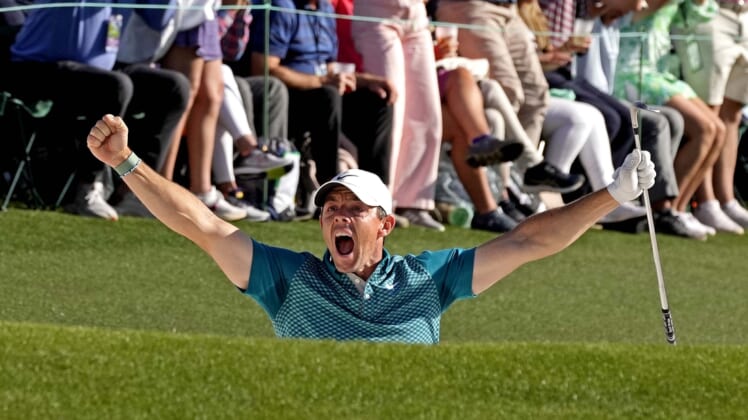 Apr 10, 2022; Augusta, Georgia, USA; Rory McIlroy celebrates after holing out from a bunker on the 18th hole during the final round of the Masters golf tournament. Mandatory Credit: Michael Madrid-USA TODAY Sports