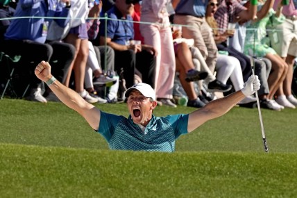 Apr 10, 2022; Augusta, Georgia, USA; Rory McIlroy celebrates after holing out from a bunker on the 18th hole during the final round of the Masters golf tournament. Mandatory Credit: Michael Madrid-USA TODAY Sports